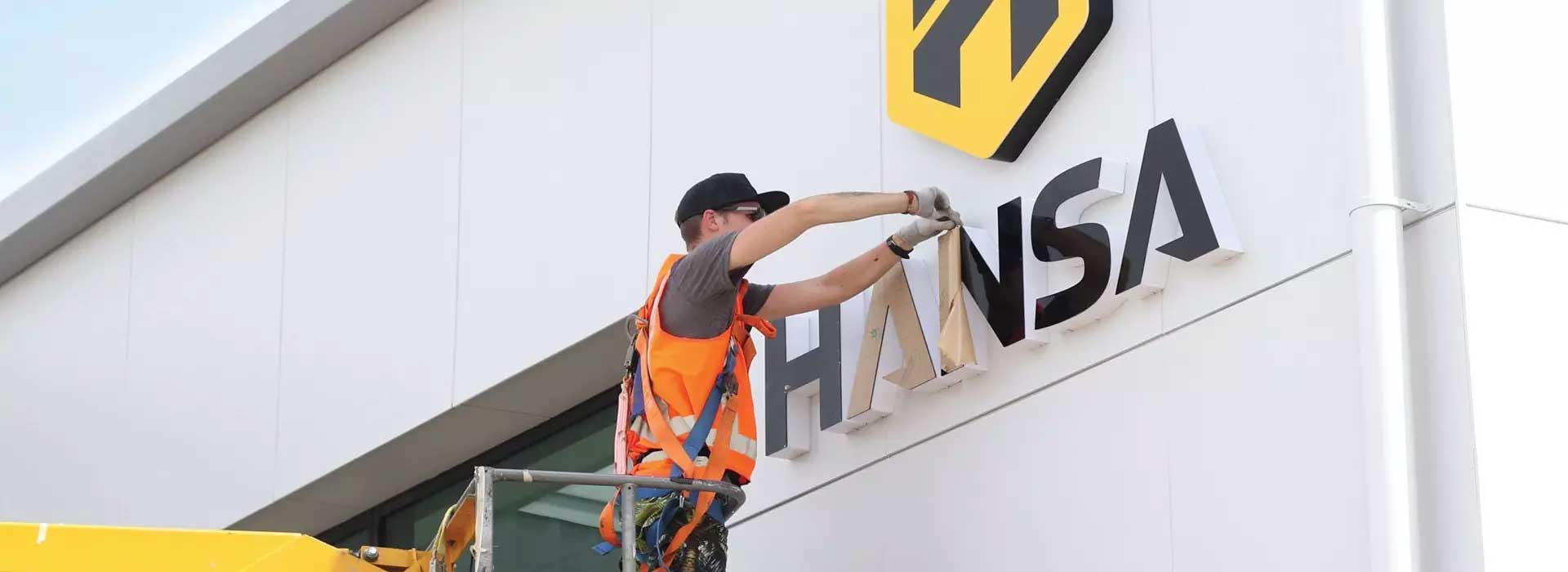 Installing signs by signage company Adelaide Bowden Print Group